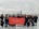 Karas So team holding Karas So LLP banner