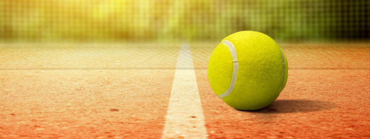 Tennis ball on court in front of net